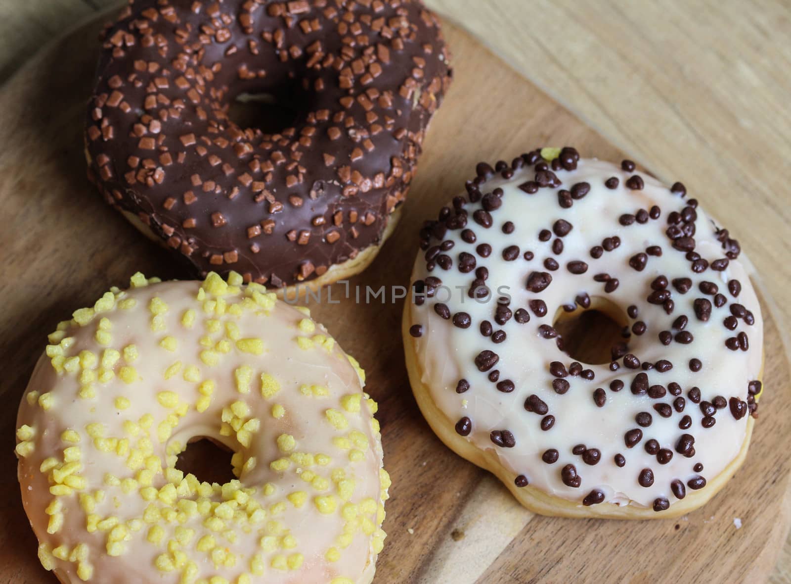 close up of different flavors of donuts