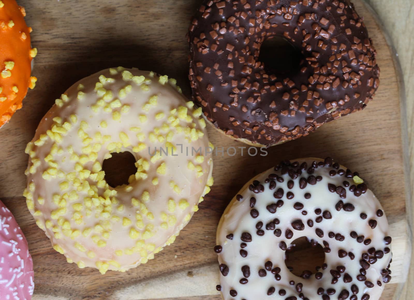 close up of different flavors of donuts