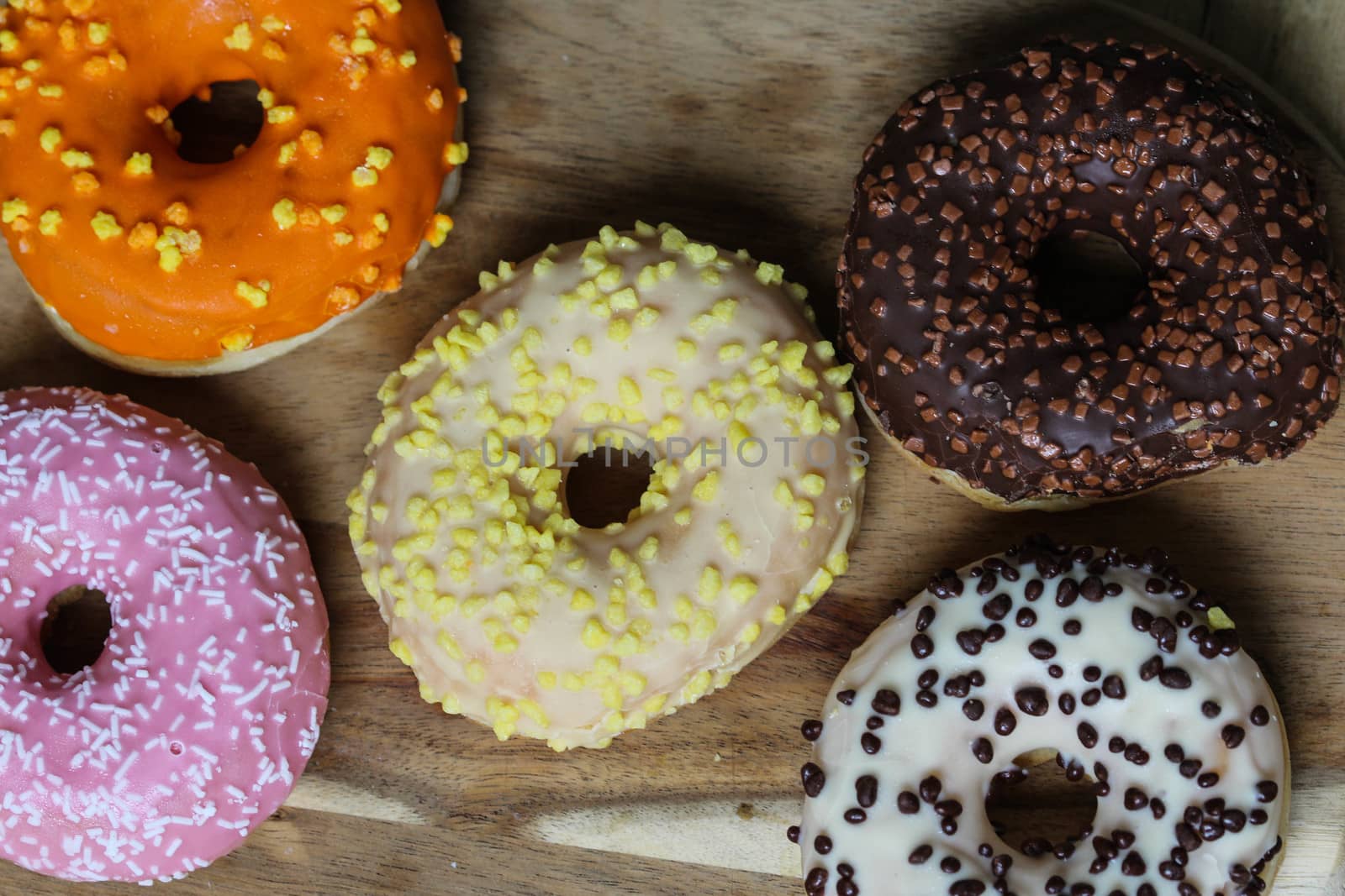 close up of different flavors of donuts