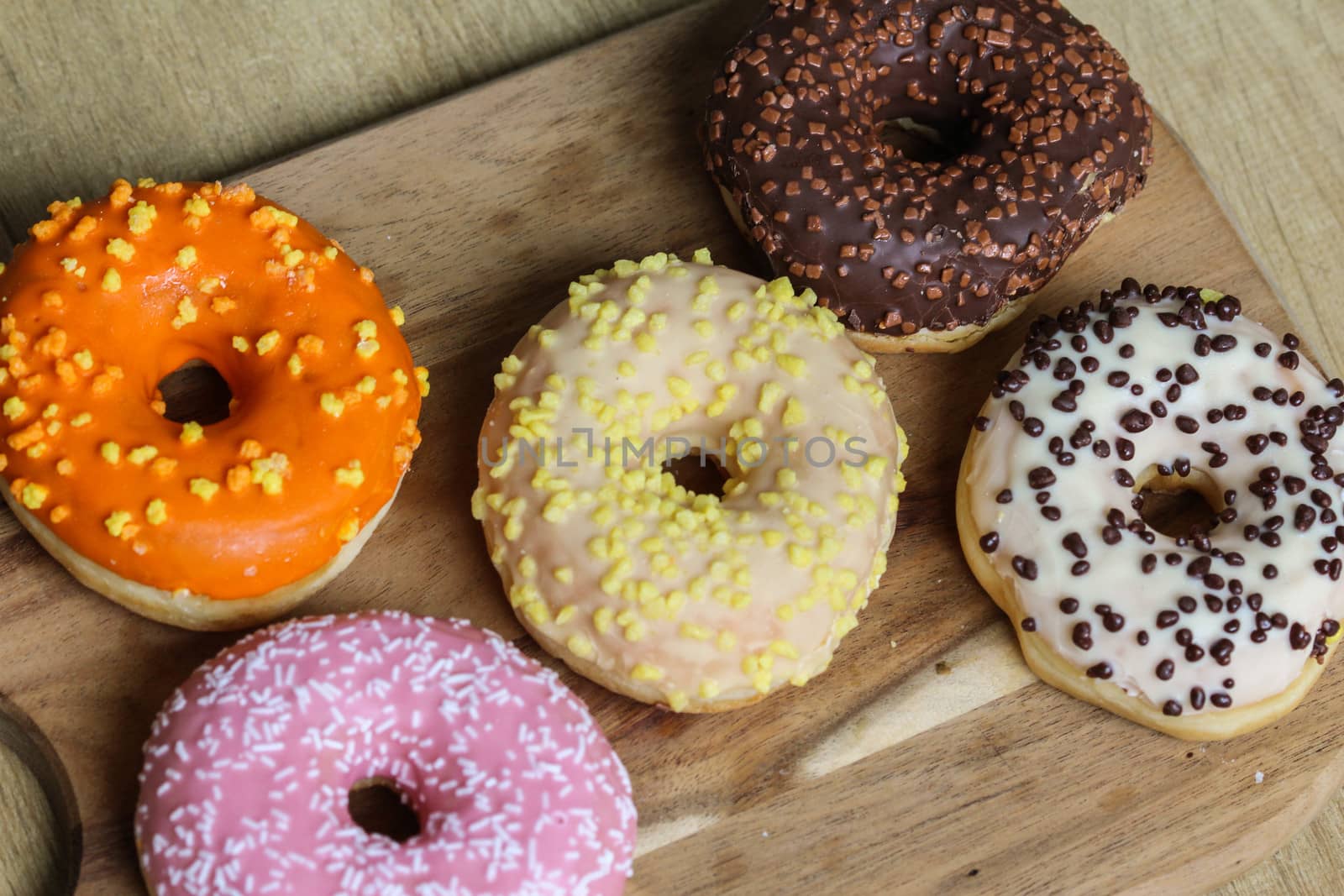 close up of different flavors of donuts