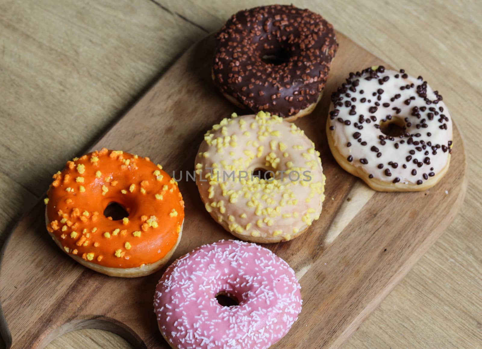 close up of different flavors of donuts