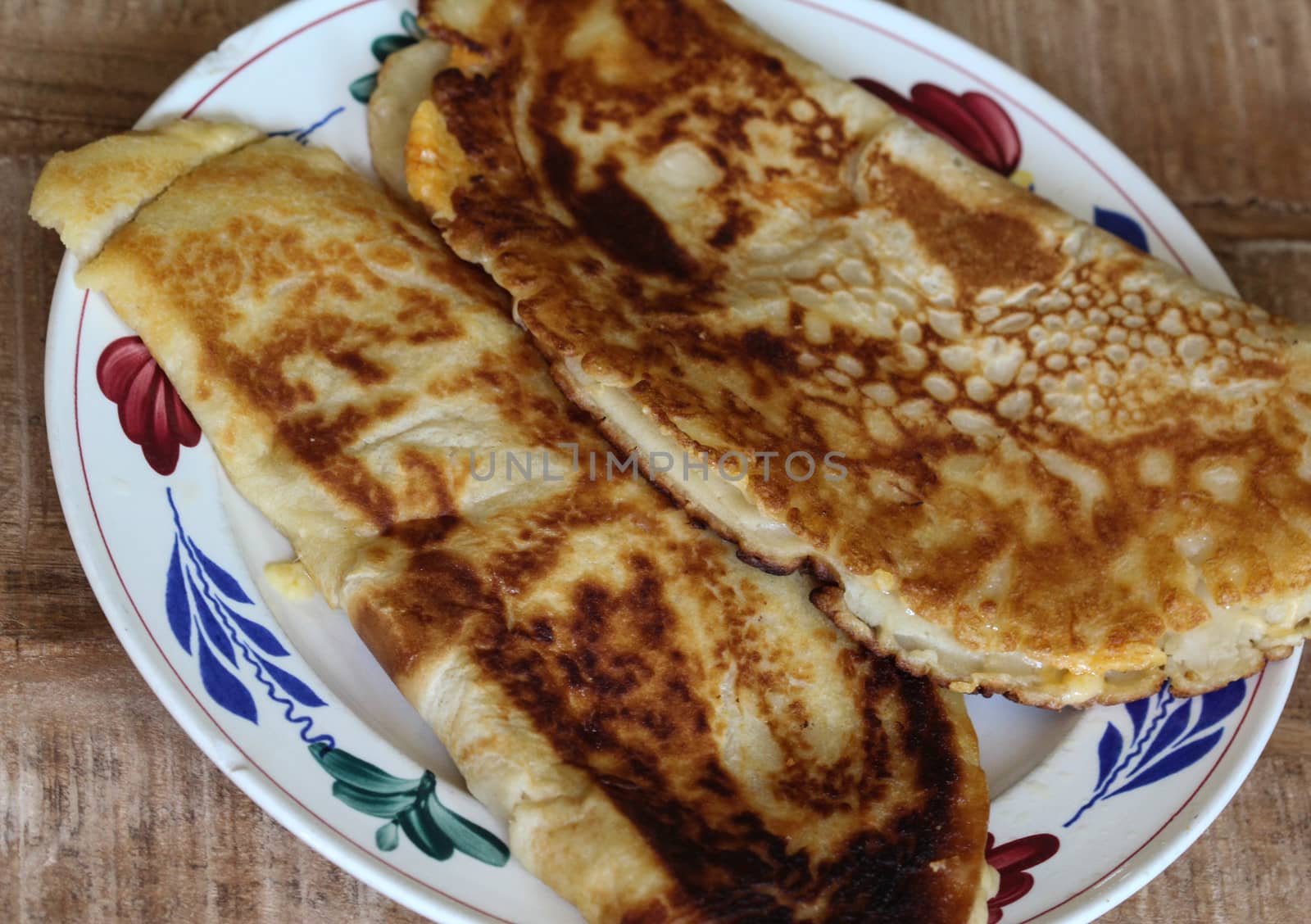close up of pancake with cheese and bacon