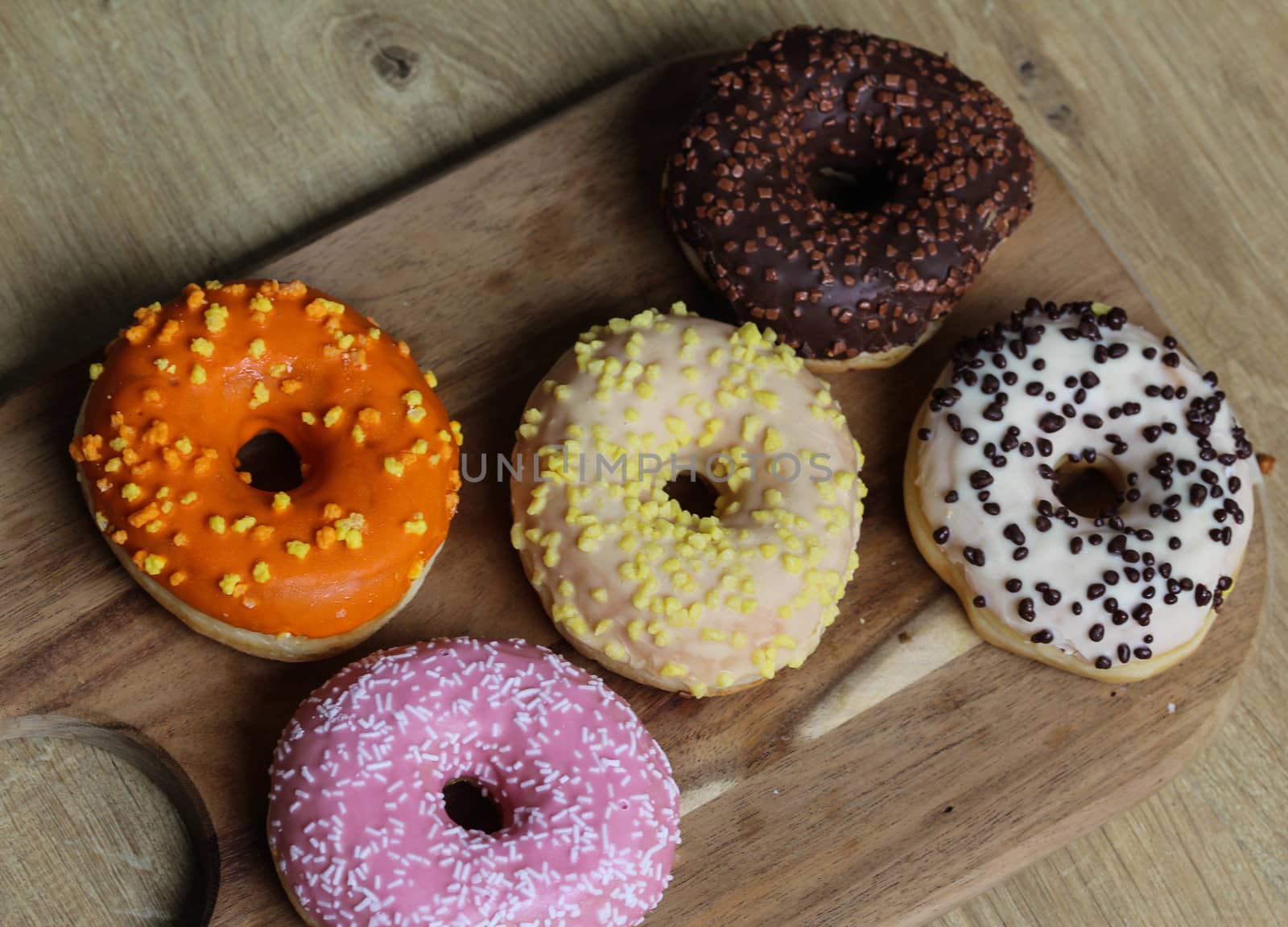 close up of different flavors of donuts