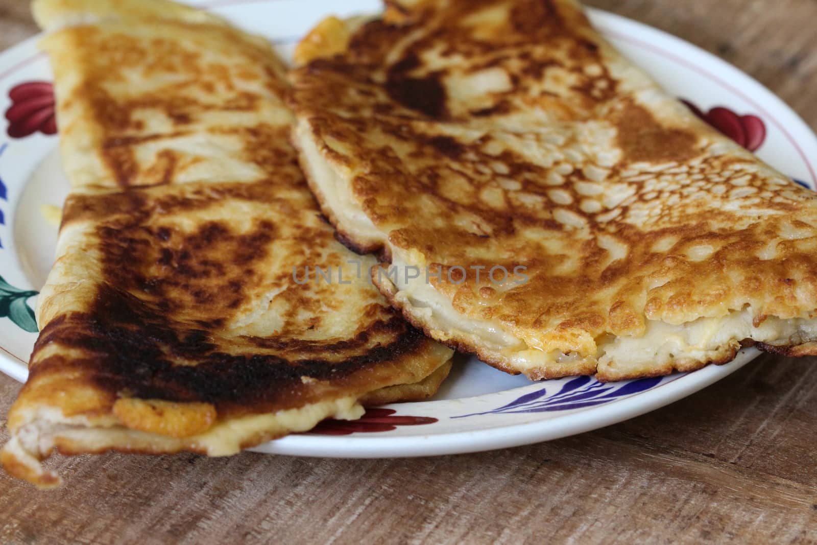 close up of pancake with cheese and bacon