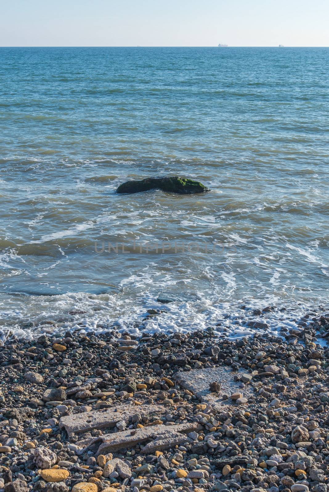 Lonely stone in the sea at the coast by Multipedia