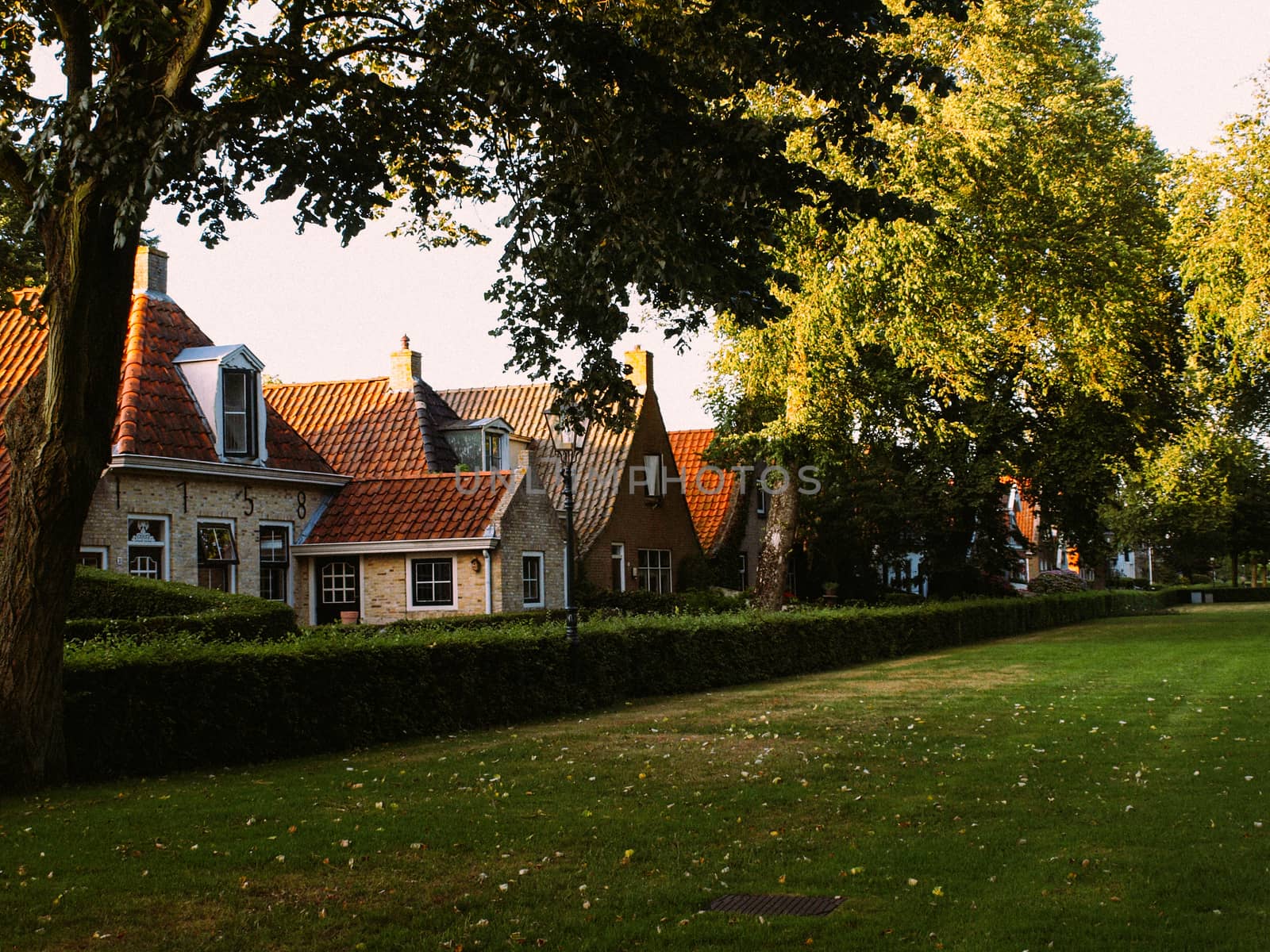 Modern row houses with brown bricks and red roof tiles in Netherlands