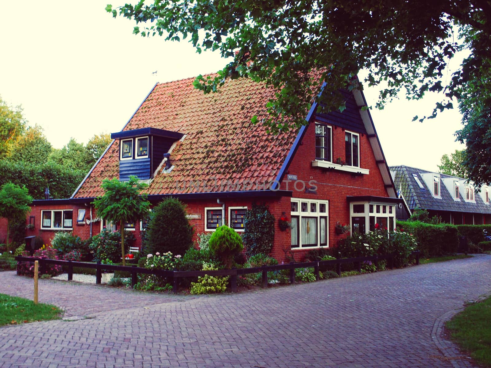 Modern row houses with brown bricks and red roof tiles in Netherlands