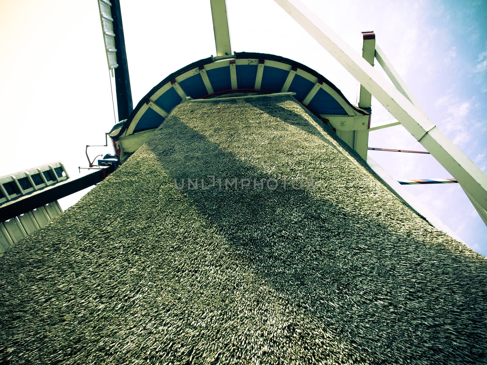 View of a windmill from the bottom up to the wings and sky