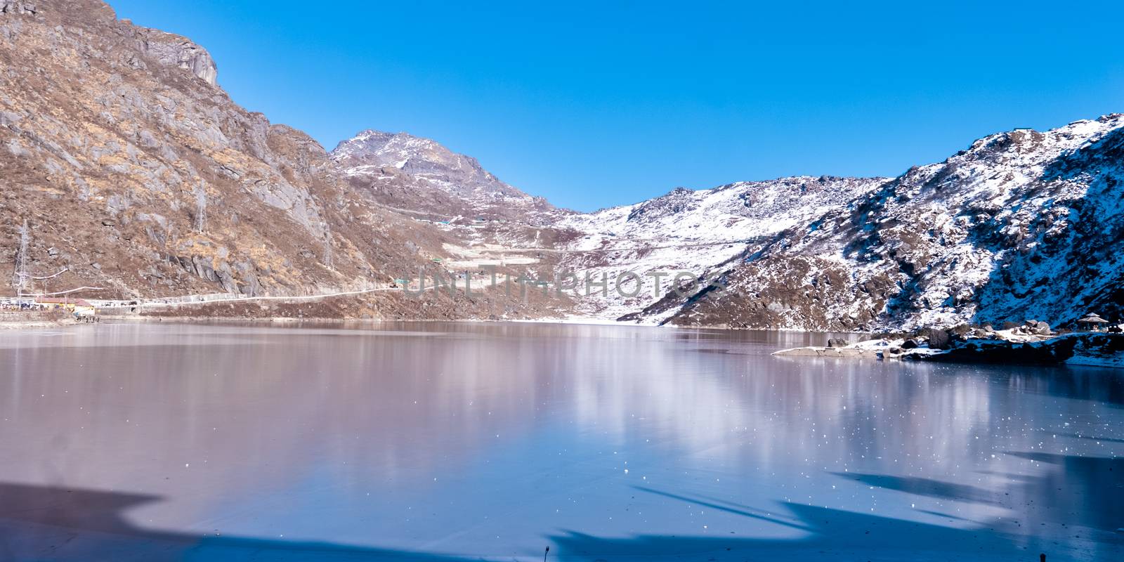 Tsomgo Lake (Tsongmo or Changu Lake) frozen during winter season. It is a glacial lake in East Gangtok Sikkim of India. Lake surface reflects different colors with change of seasons. Landscape View by sudiptabhowmick