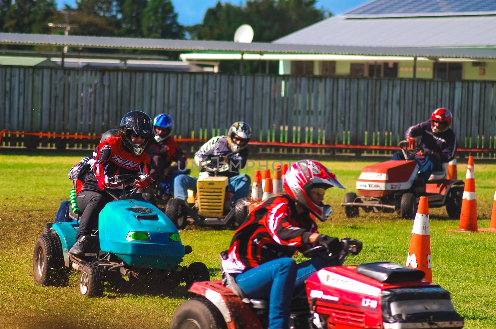 A few drivers participating in a lawnmower race