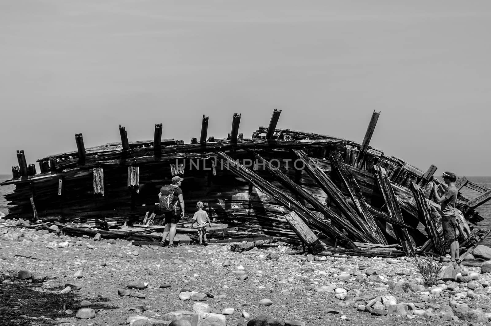 An abandoned wooden boat by the coast