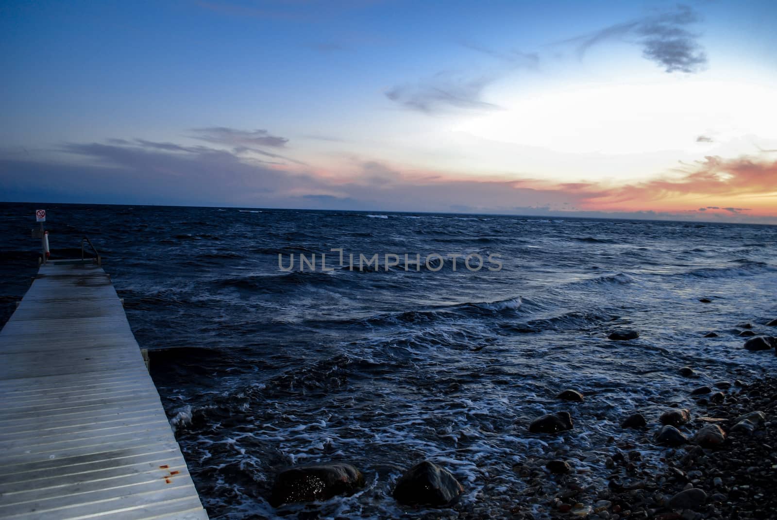 Sunset over a jetty by the ocean