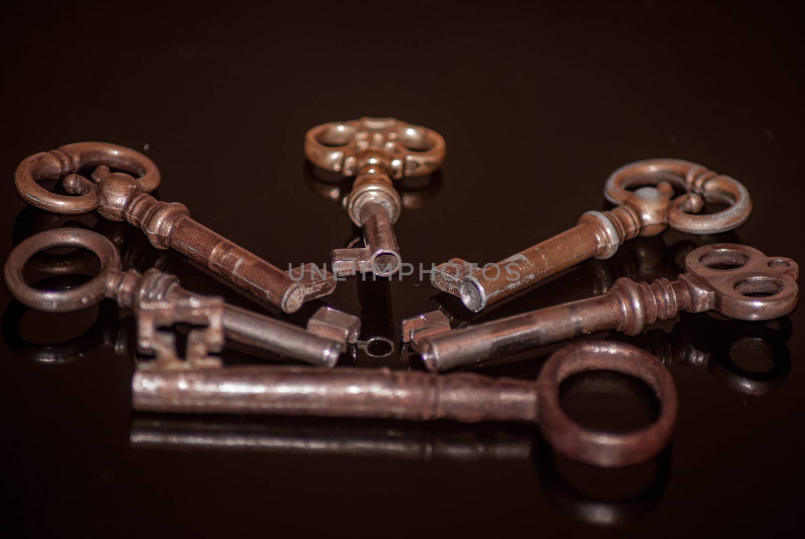 Six old rusty keys with reflections