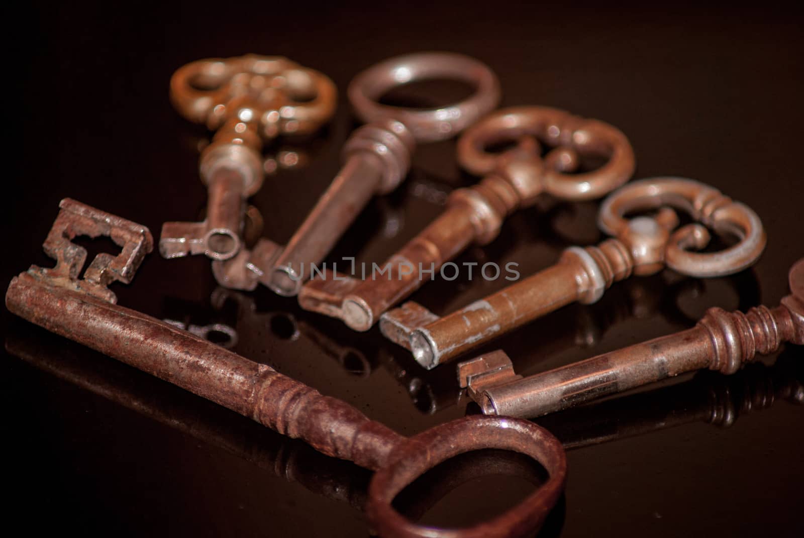 Six old rusty keys with reflections