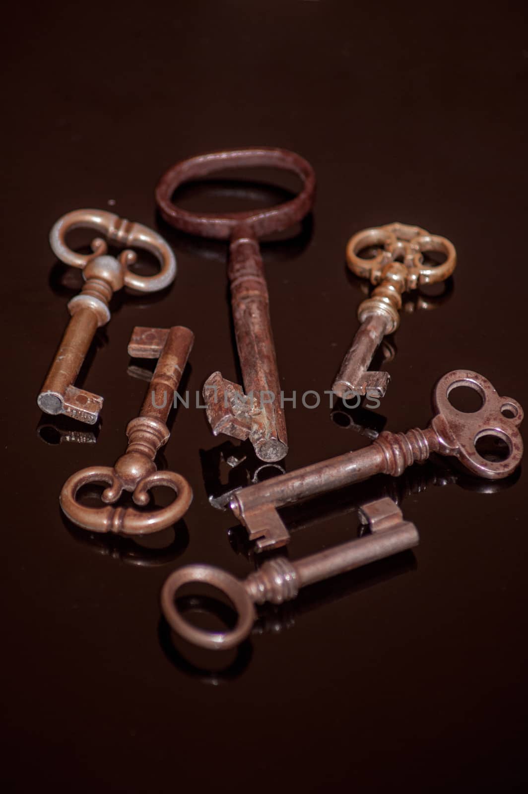 Six old rusty keys with reflections