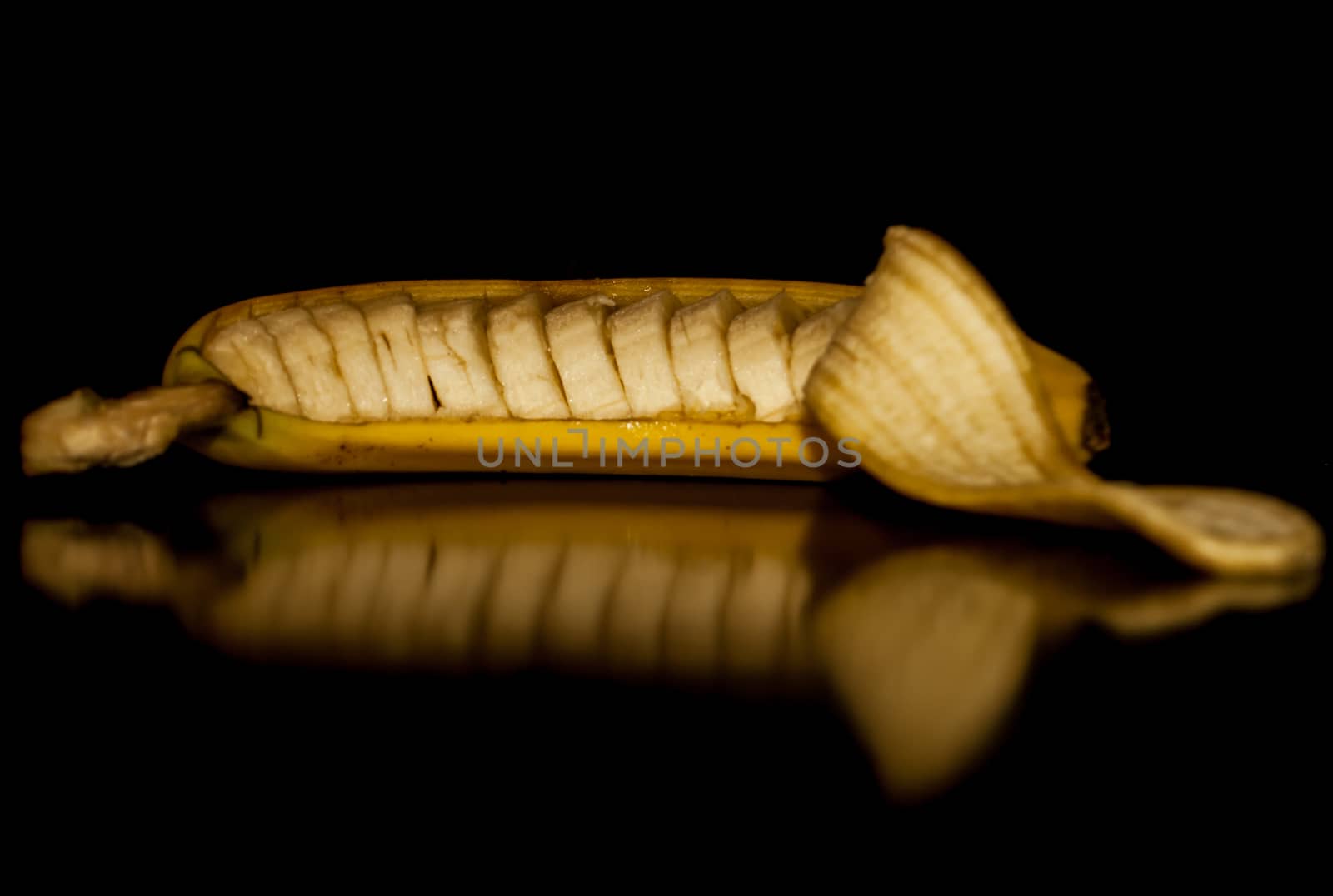 A cut banana still in its peel