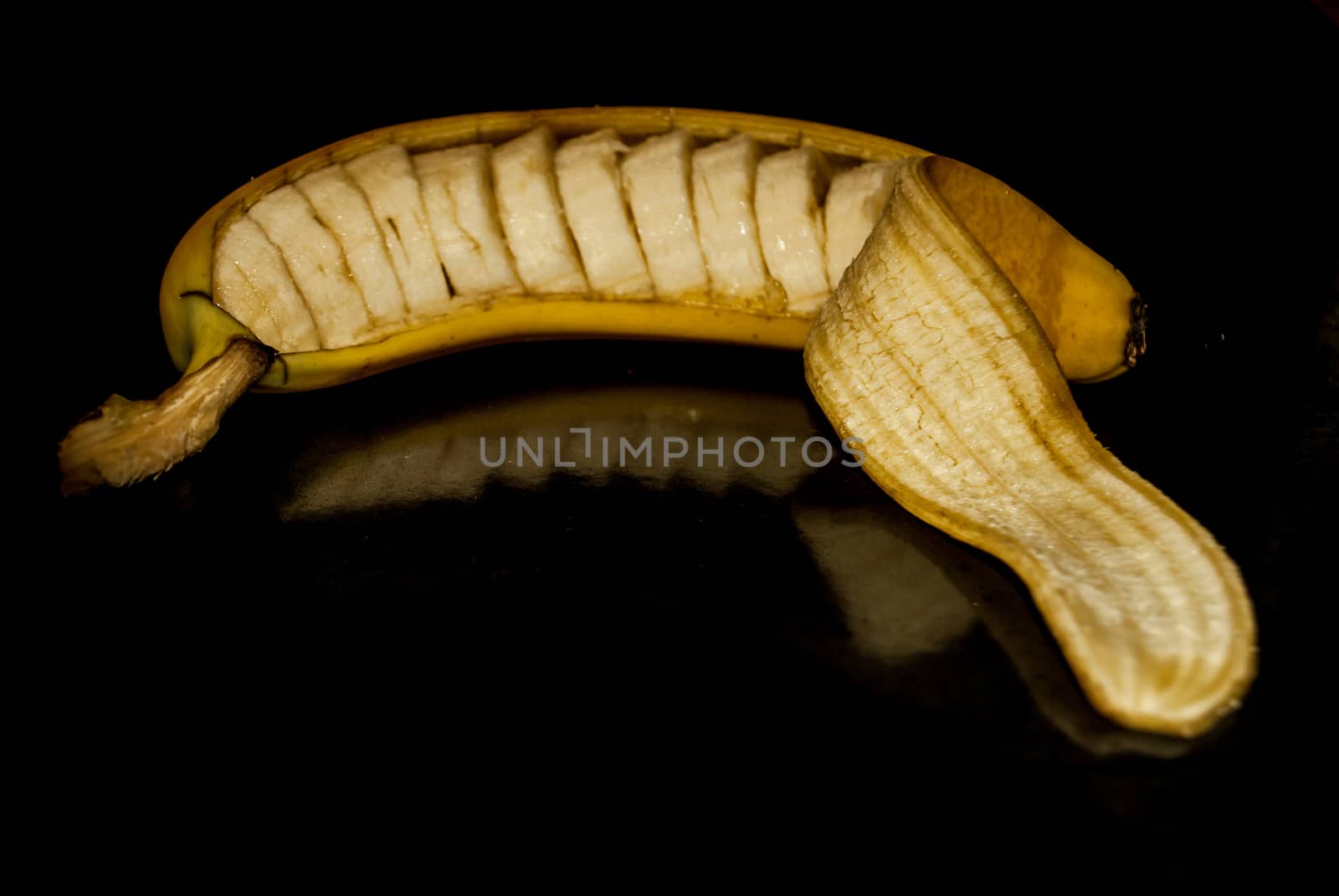 A cut banana still in its peel