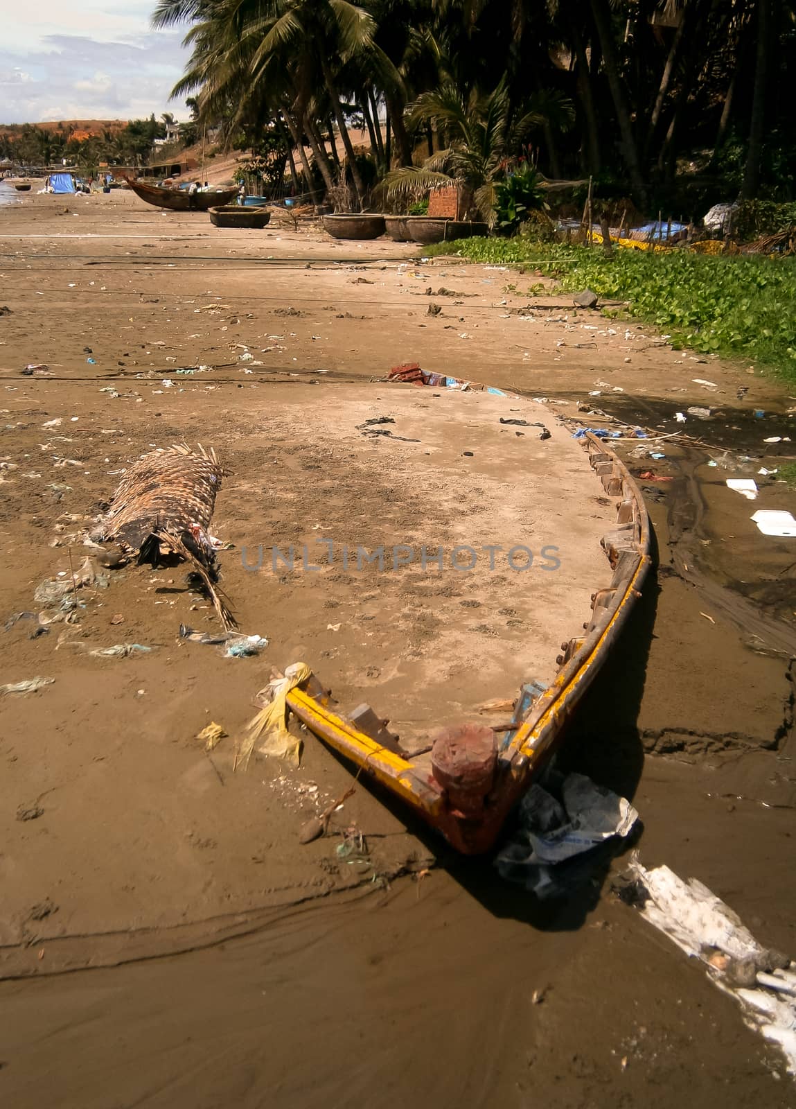 An abandoned boat covered in sand