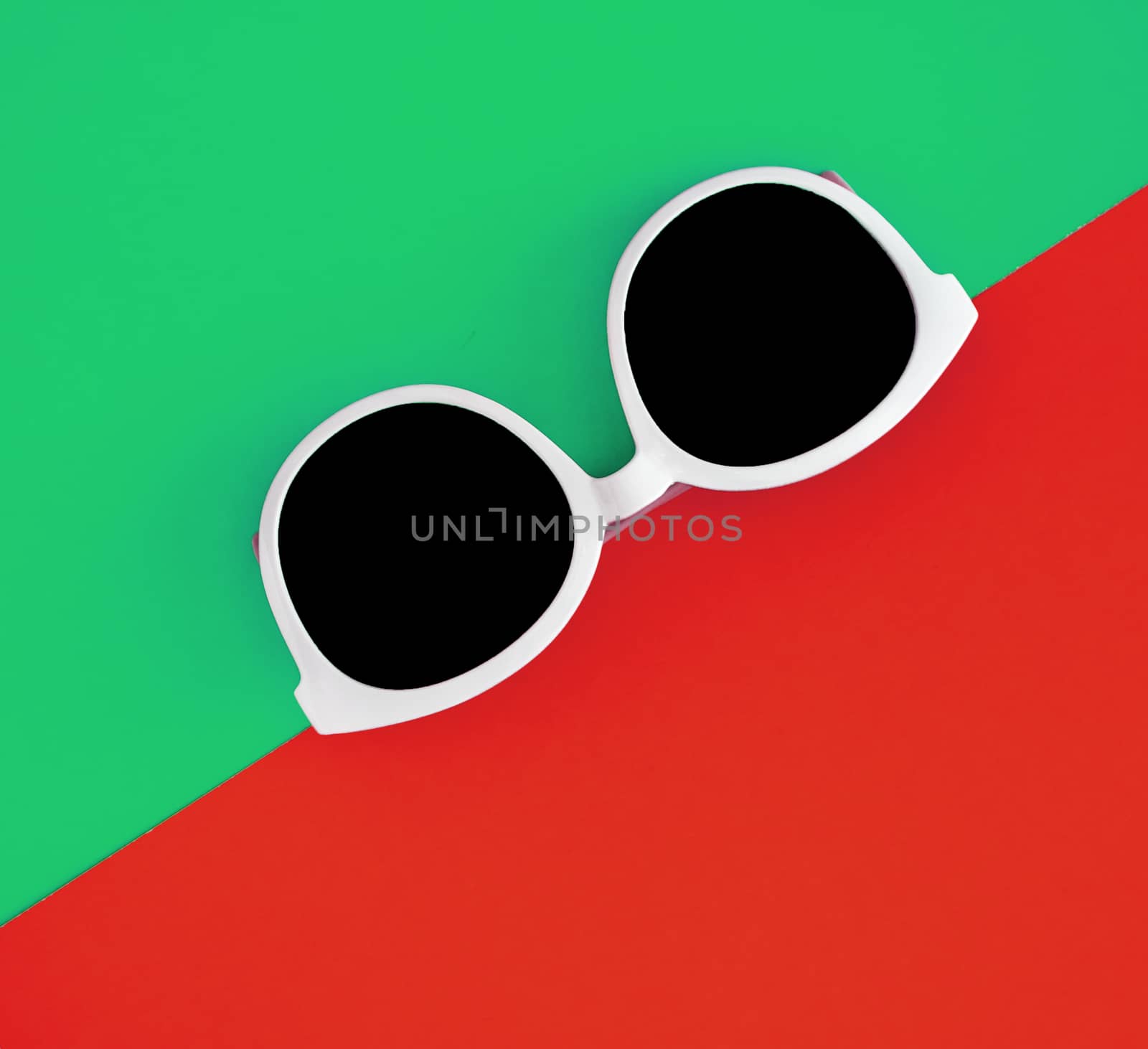 Sunny stylish white sunglasses on a bright green-cyan and red-or by Tanacha