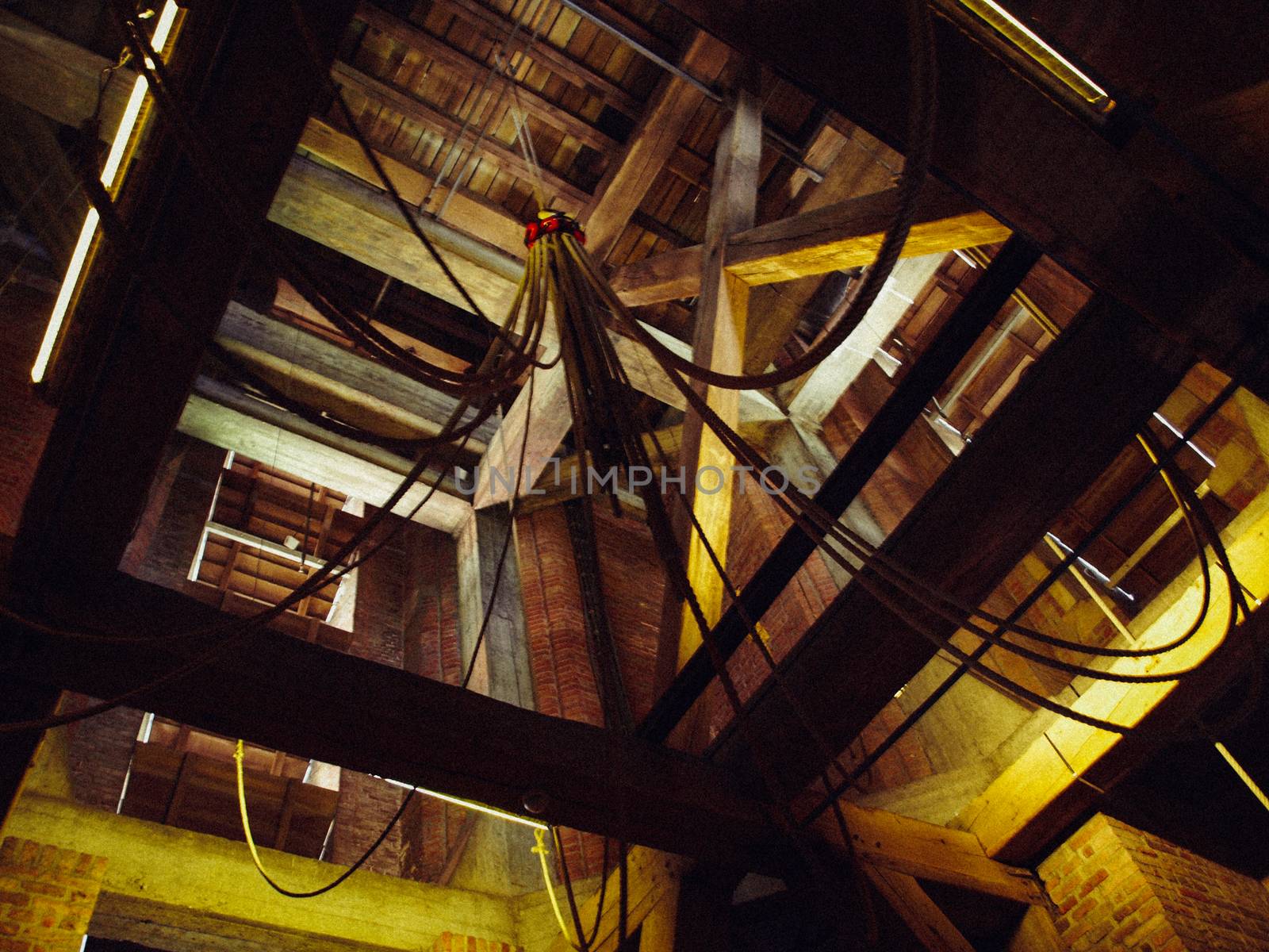 Belfry interior in old village bell tower, wooden beams, stair, bells at Netherlands
