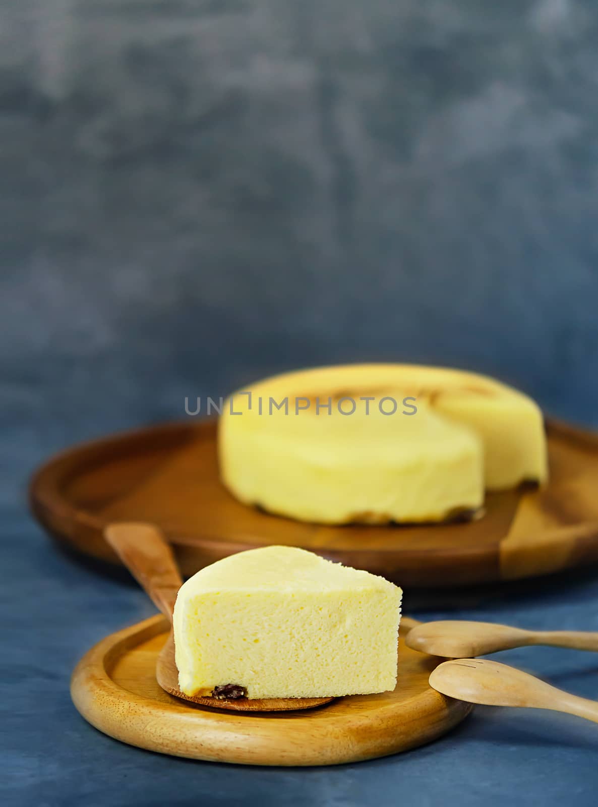 Tasty homemade cheesecake on wooden plate