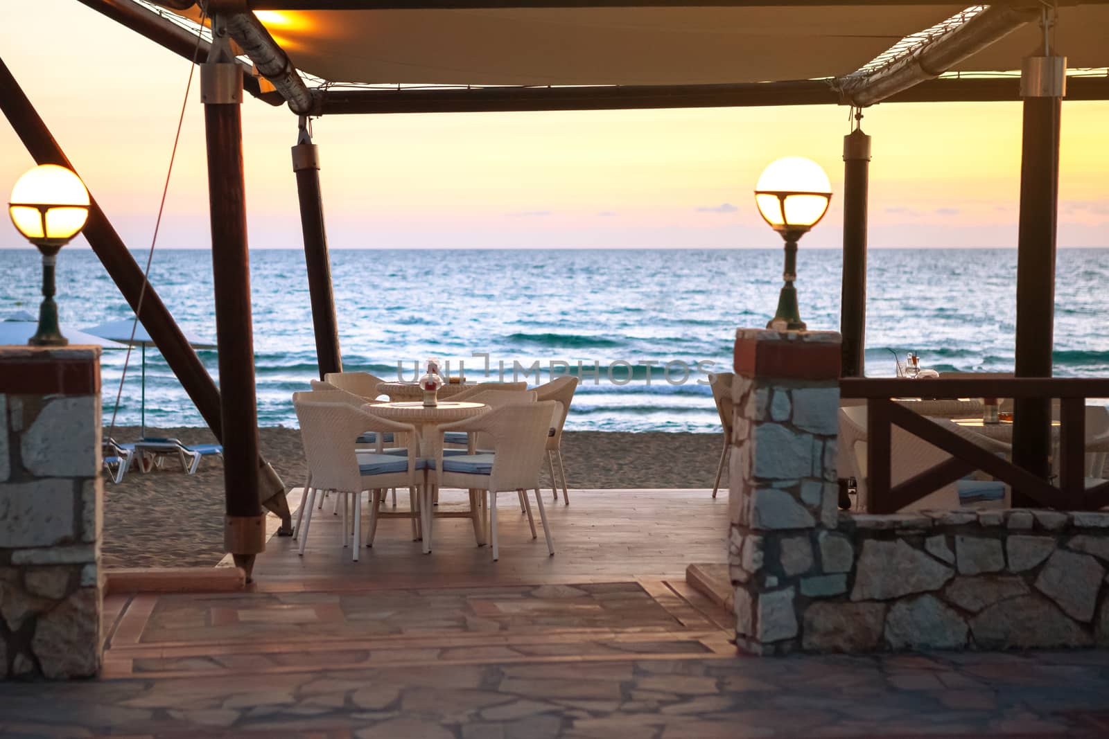 Entrance to empty cafe on sandy beach at sunset. concept of travel and long awaited vacation. velvet season.