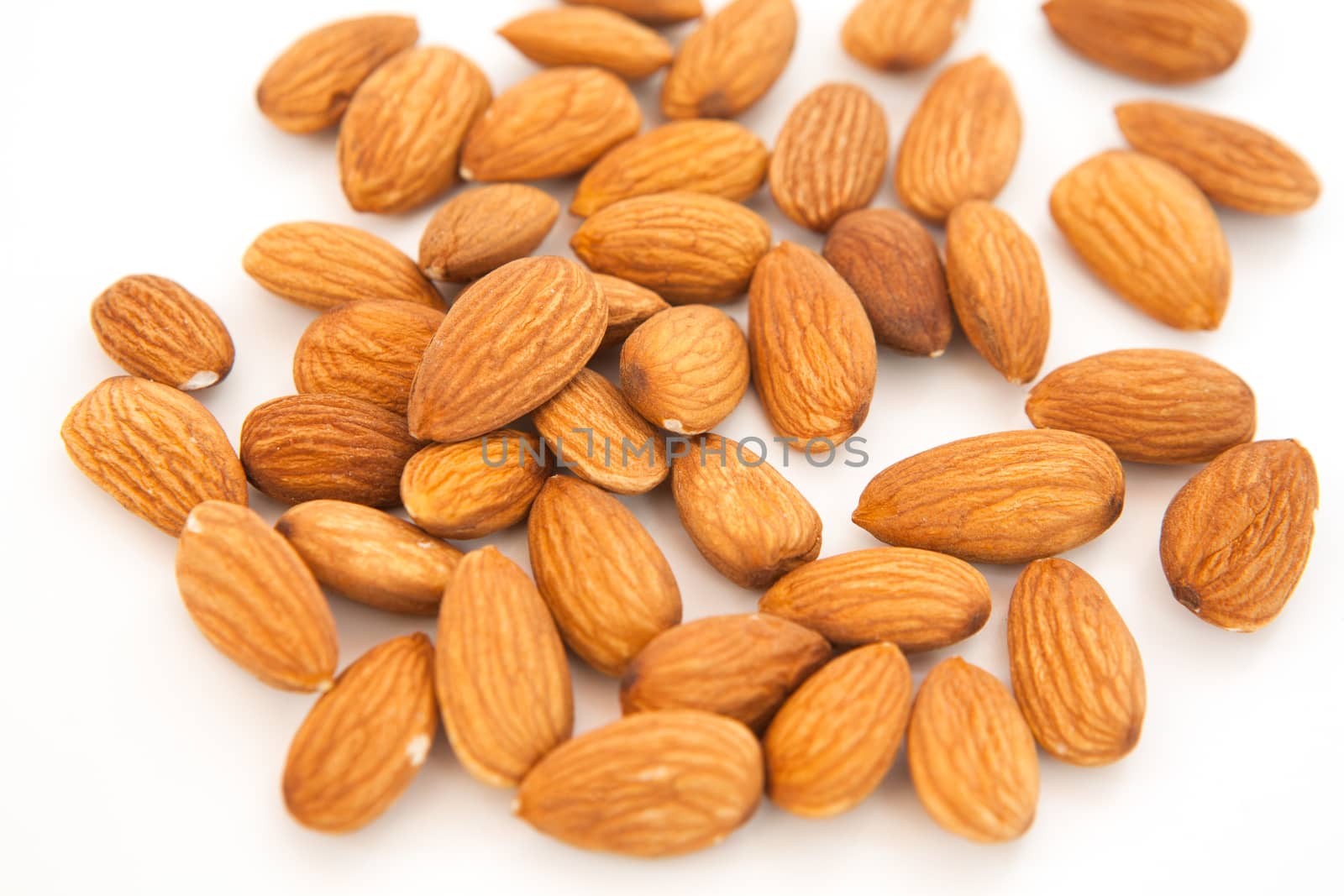 Almond superfood isolated on white background. Concept of healthy life. Close up. Nuts fill the whole frame.