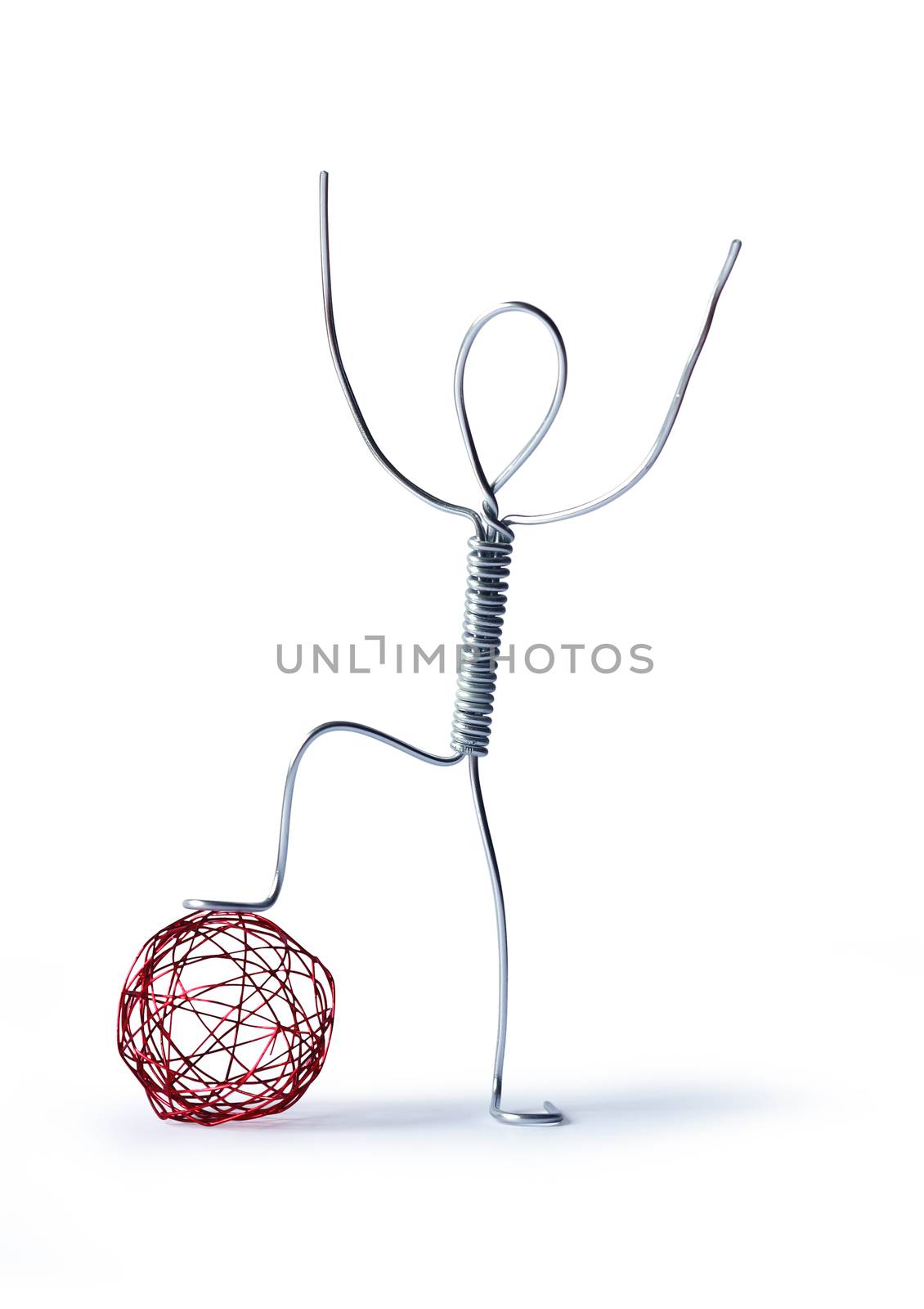 Football concept. Fun man made from aluminum wire near ball