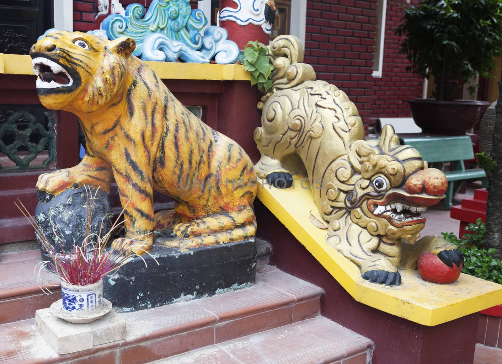 Tiger and lion statuesat the entrance of a temple, Vietnam