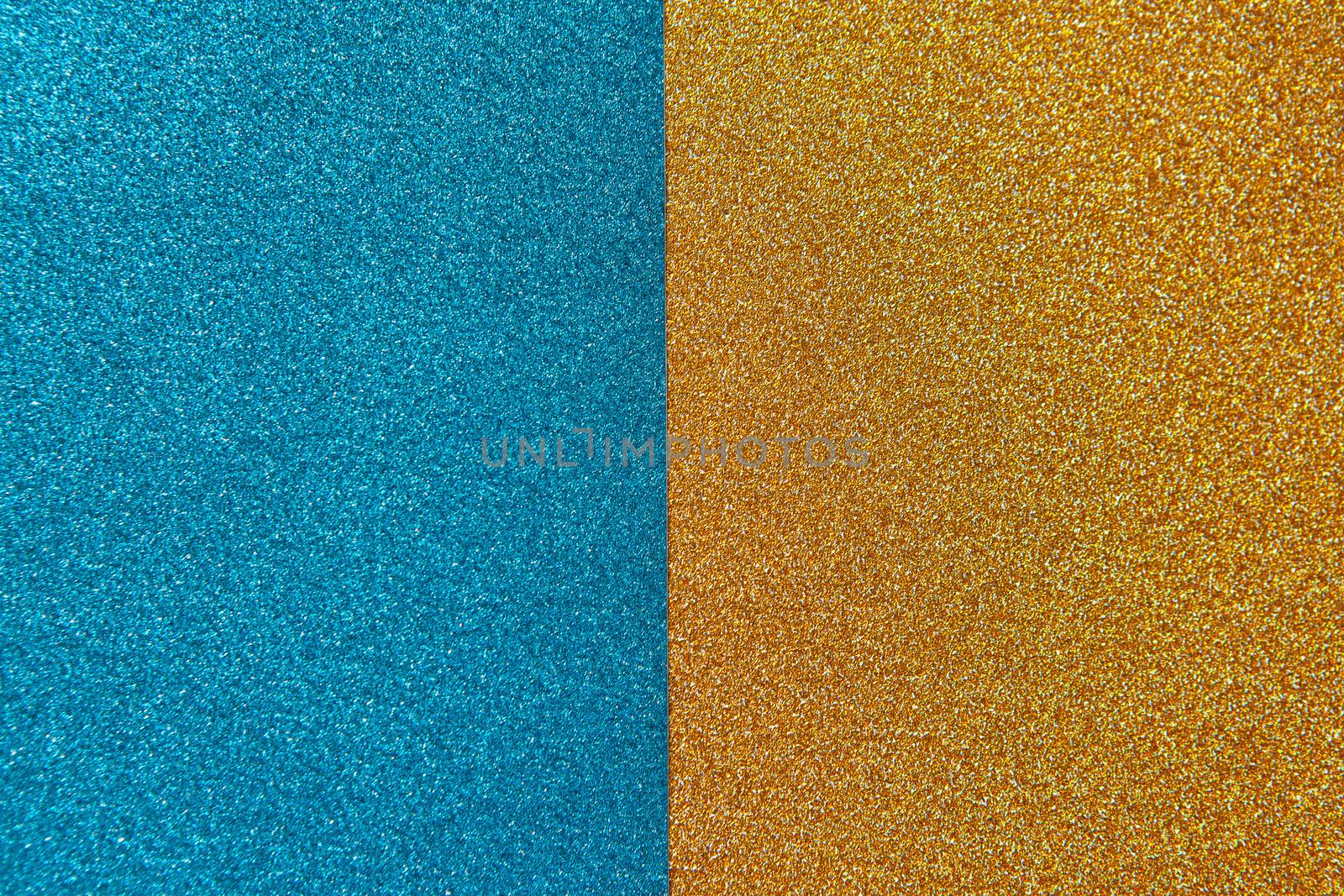 Bright festive brilliant background, consisting of two halves, blue and gold. Horizontal. Copy space for text. Celebration, holidays, travel concept