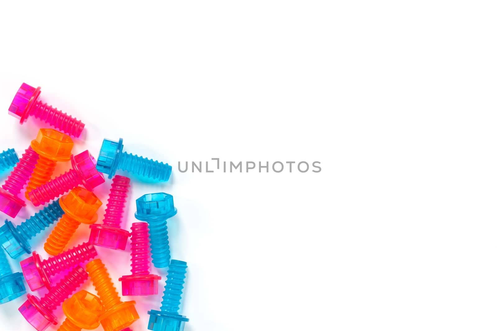 Colored translucent toy bolts isolated on white background. Flat lay. Concept of World Dad's Day, unisex toys for early development, role-playing games. Layout for social media, for toy stores.