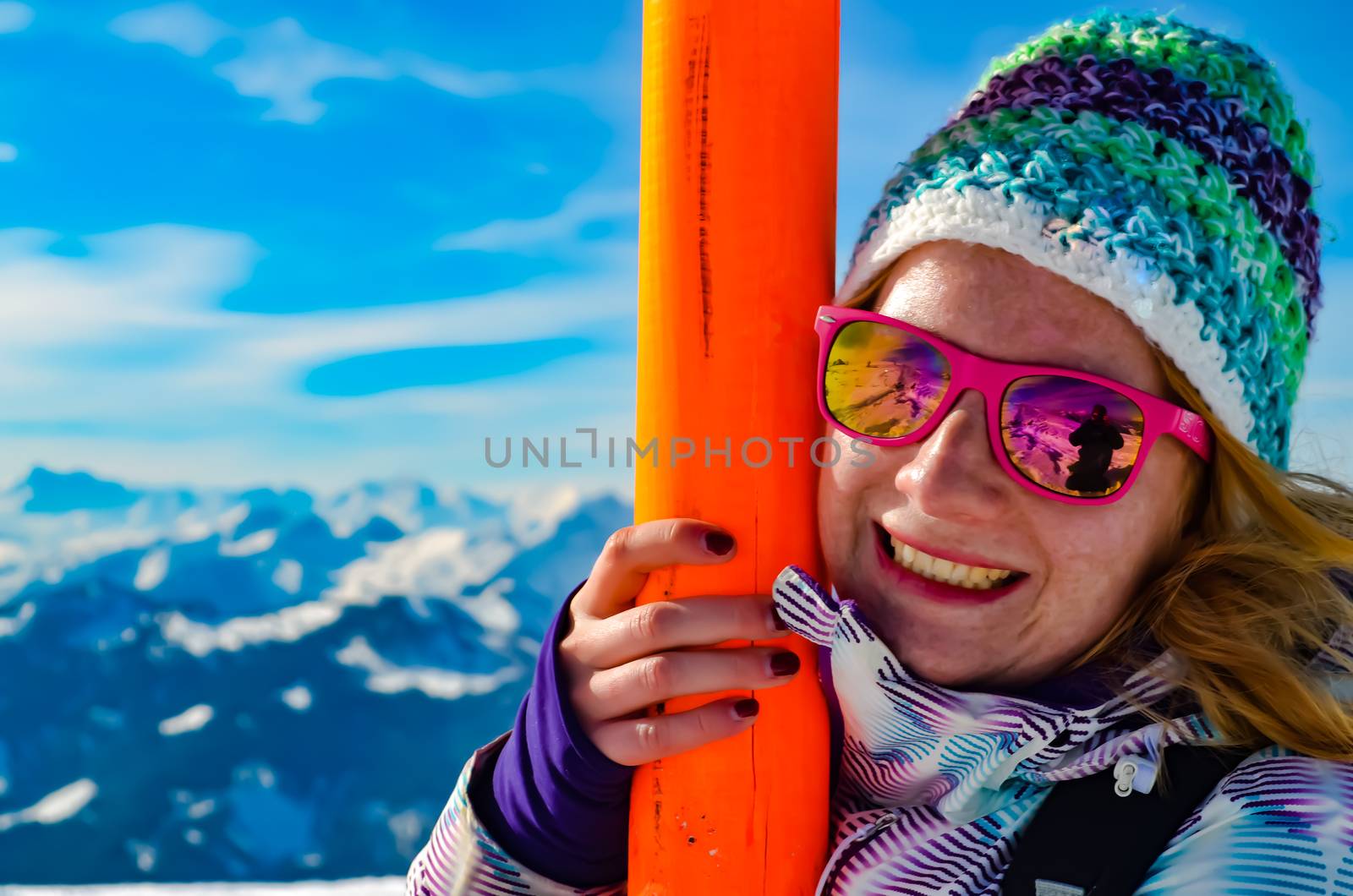 Women Hanging onto a Ski Post taken in the Mountains of Flachau Austria