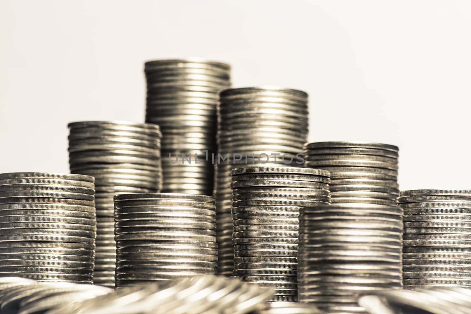 A lot of coins, selective focus.Front view of stacks of Euro coins.Concept photo.Coins close-up on the table. Simple and minimalistic design .