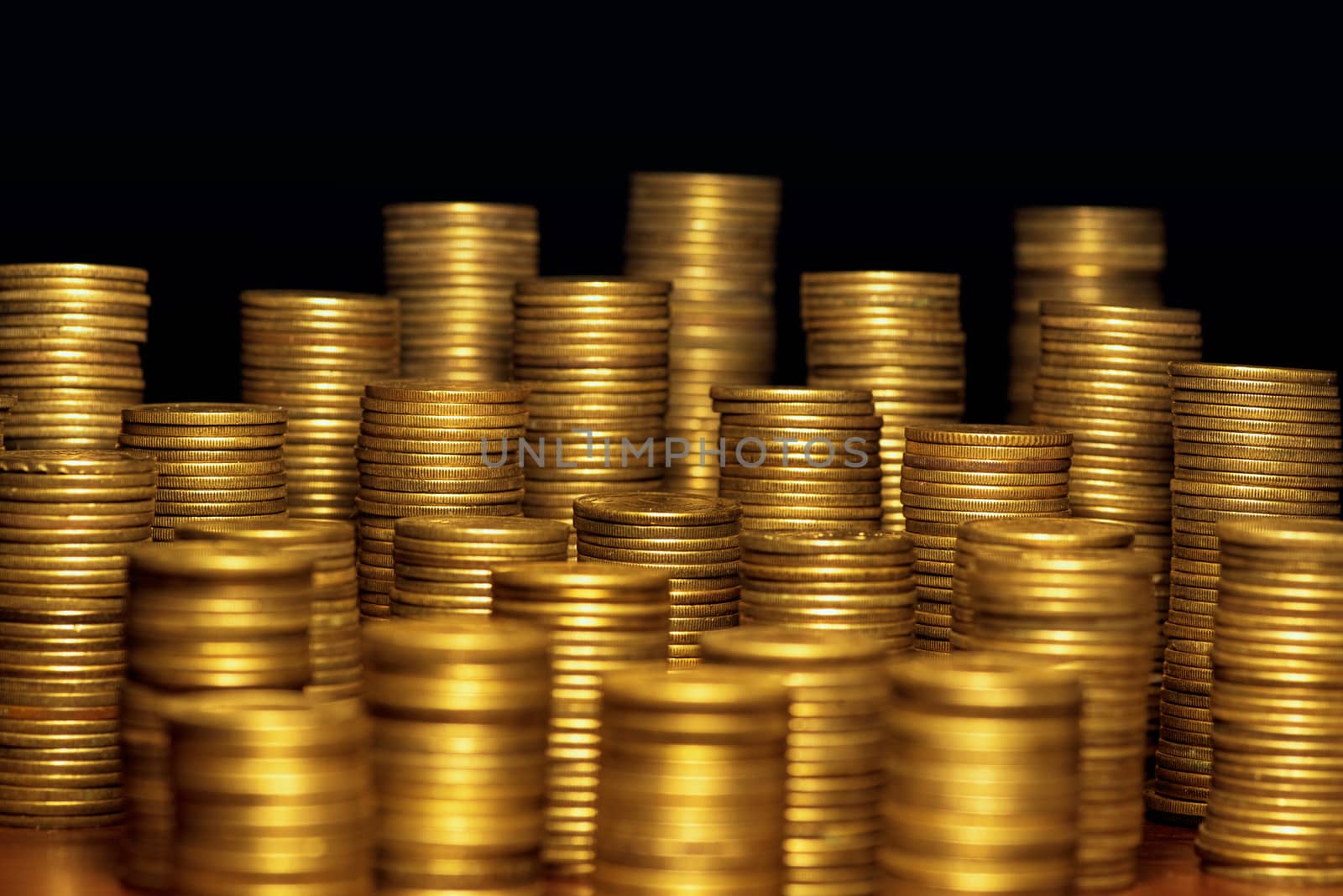 A lot of coins, selective focus.Front view of stacks of Euro coins.Concept photo.Coins close-up on the table. Simple and minimalistic design .