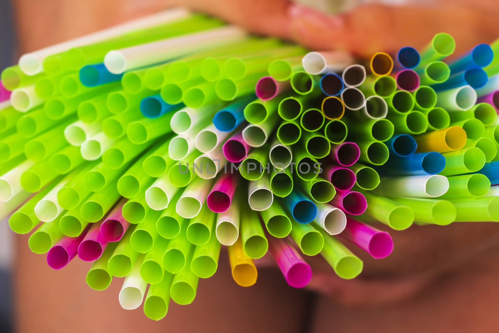 Abstract colorful background. Background from cocktail tubes close up. Soft focus. Cocktail tubes of different colors close up.Close-up of straw tubes.
