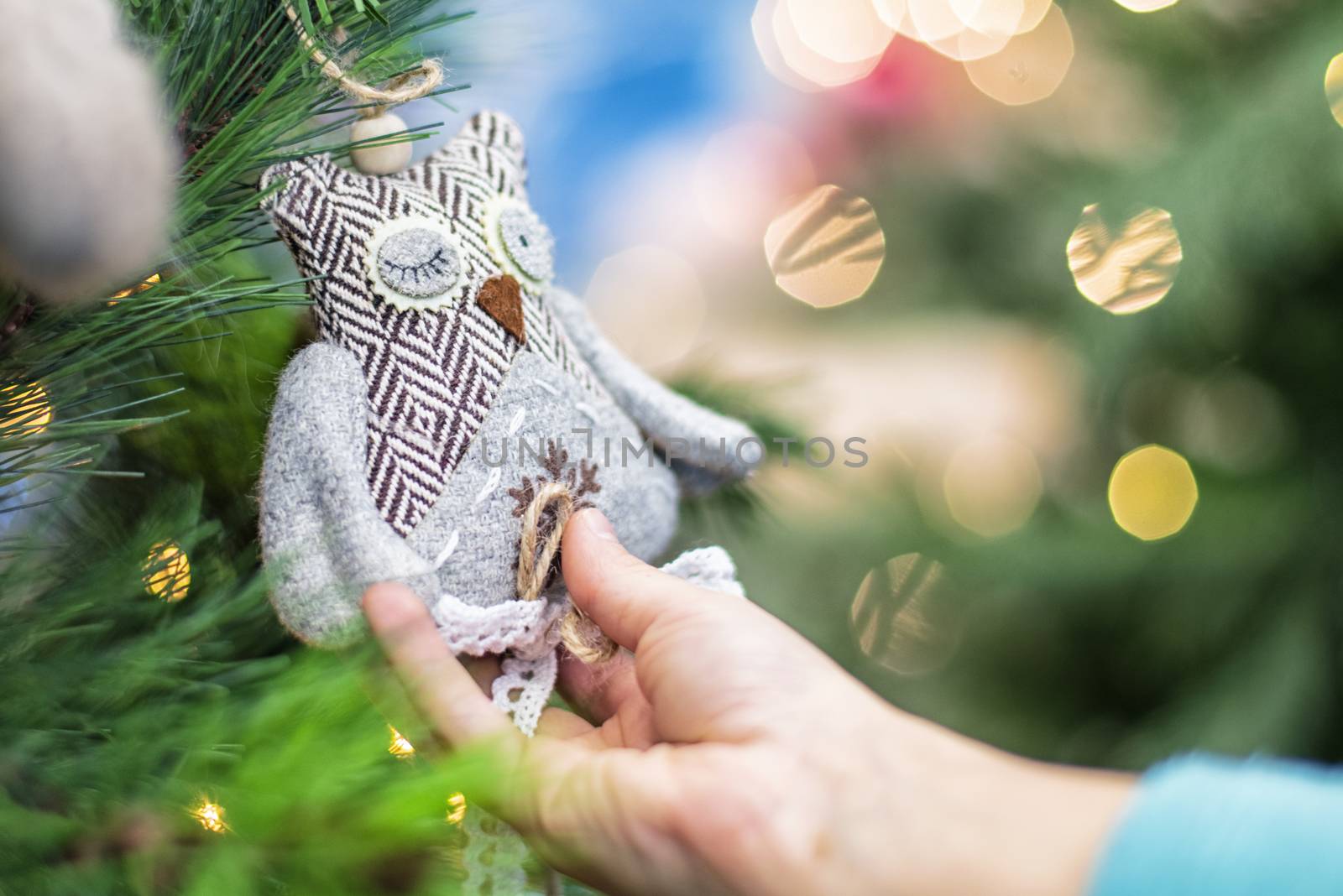 Christmas toy in the hands of a child.Children hands hold the decor at the Christmas tree on which the New Year's toys are hanging . Xmas concept.