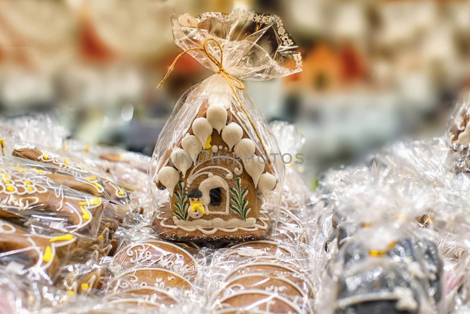 Gingerbread house wrapped. Lots of gingerbread houses.Homemade Christmas Gingerbread House displayed on a table.