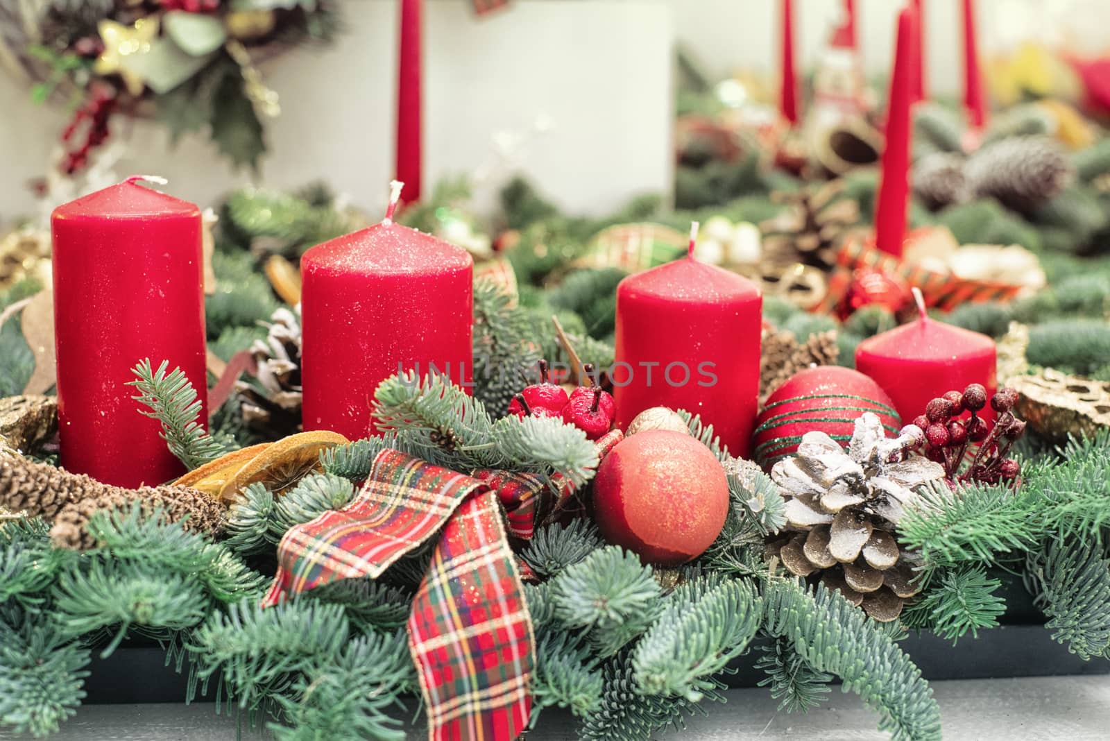 Decorative Christmas tree branches with candle ,Christmas candles decoration with flowers on a table.