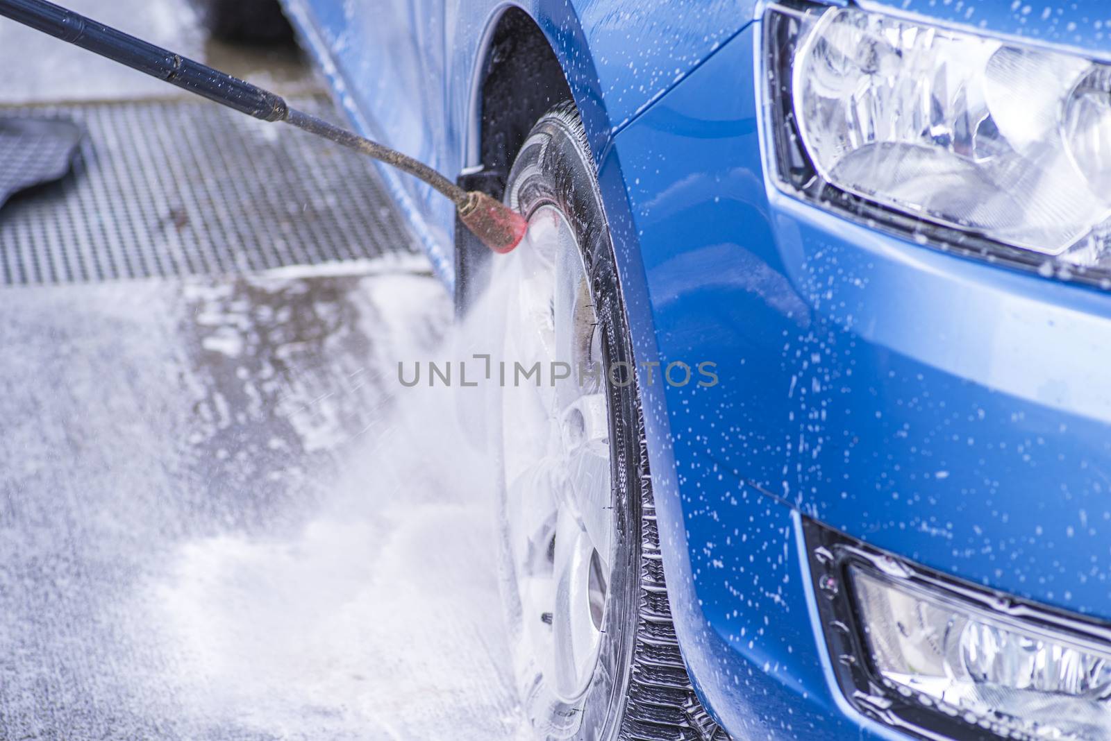 Cleaning Car Using High Pressure Water.Manual car wash with pressurized water in car wash outside.