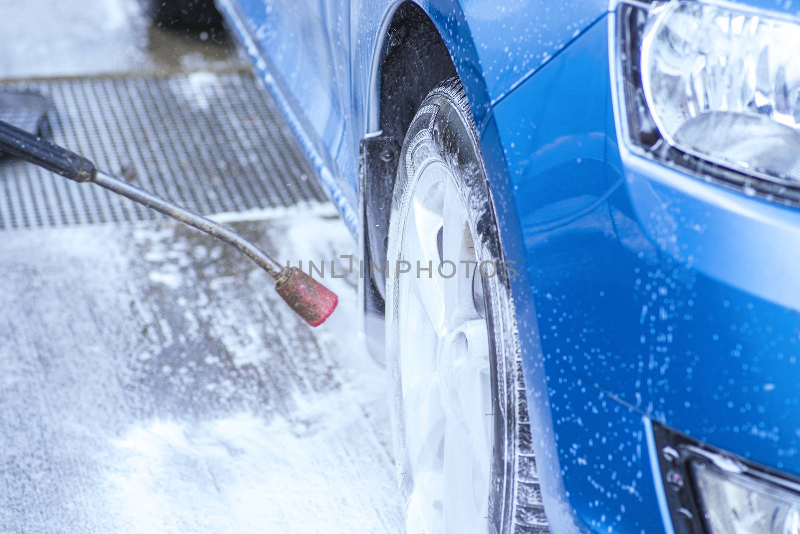 Cleaning Car Using High Pressure Water.Manual car wash with pressurized water in car wash outside.