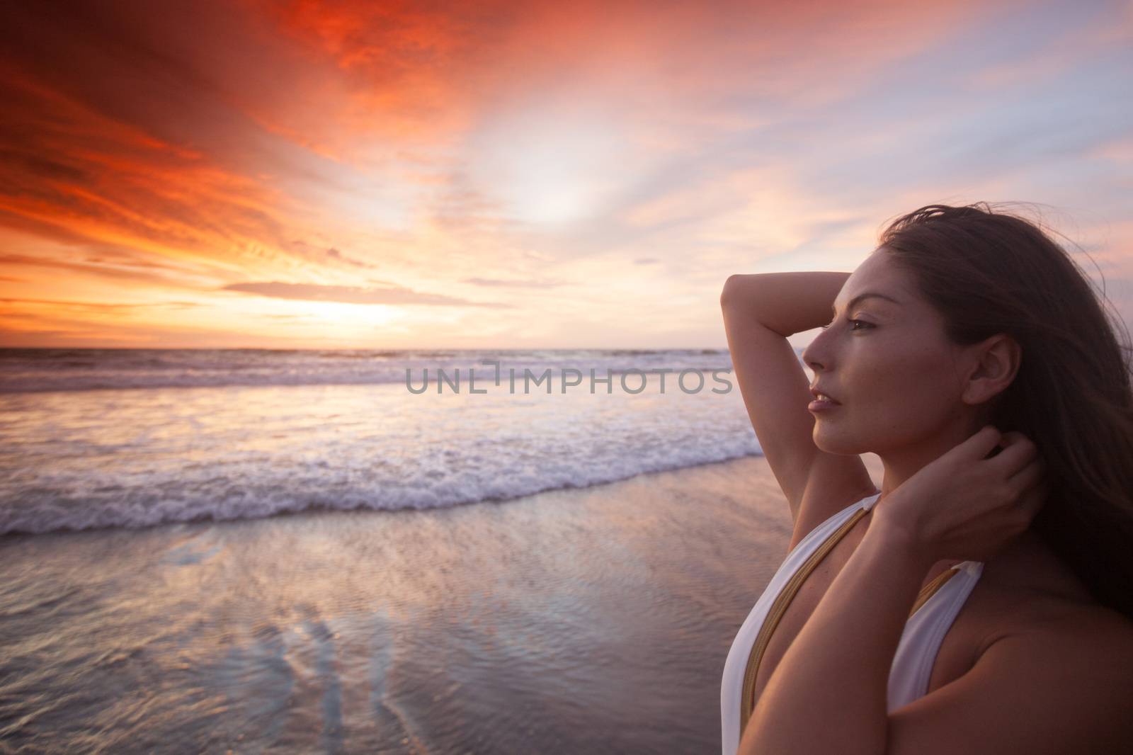 Woman on the beach at sunset by Yellowj