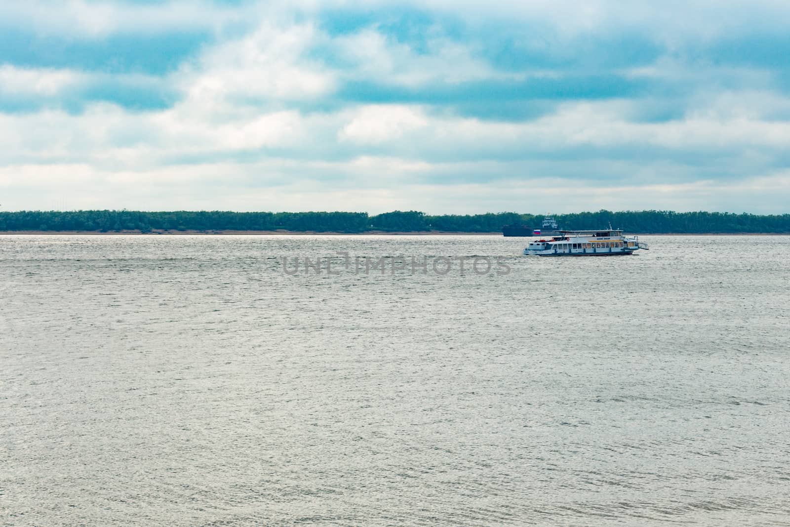 View of the Amur river against the blue sky with white beautiful clouds. Bright spring sun. Russia, Khabarovsk. by rdv27