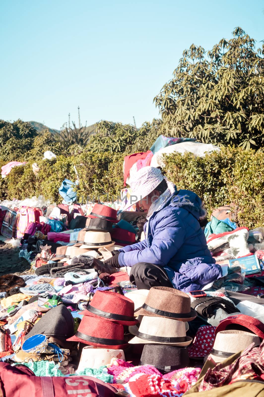 Police Bazar, Shillong Meghalaya India December 2018 - A vendor selling Headgear cap or hat of variety color tradition. Flea Market is the best shopping hub of local arts crafts handicrafts products. by sudiptabhowmick