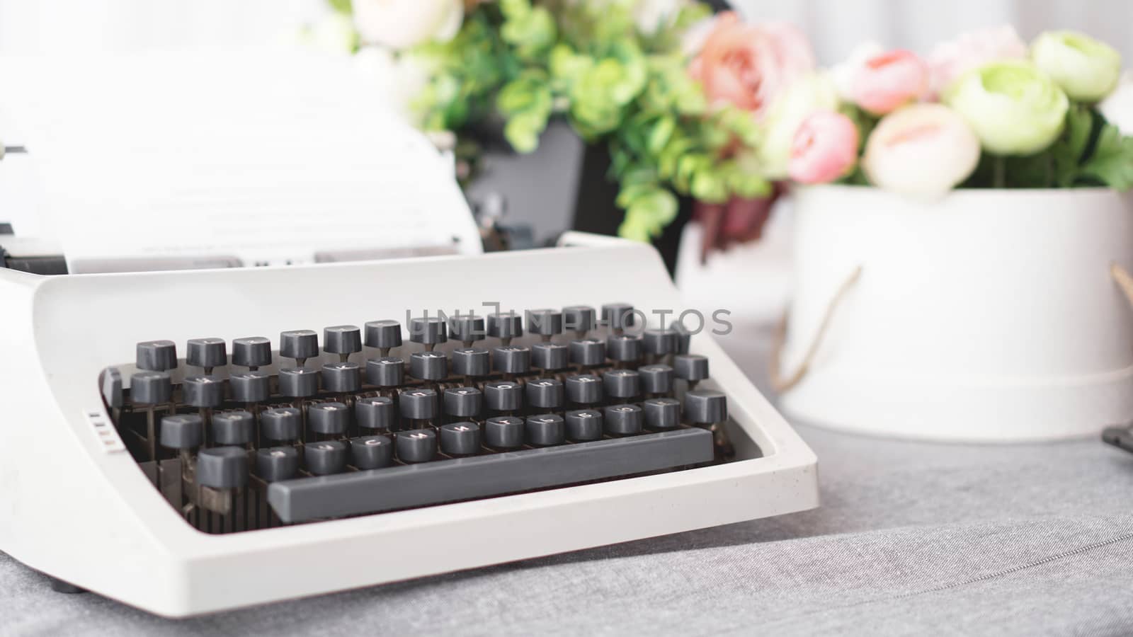 Vintage typewriter with paper. retro machine technology - white background with flowers