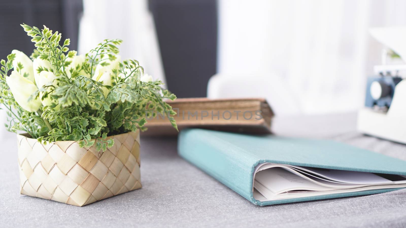 Female workspace with flowers bouquet on white background. Womens office desk by natali_brill