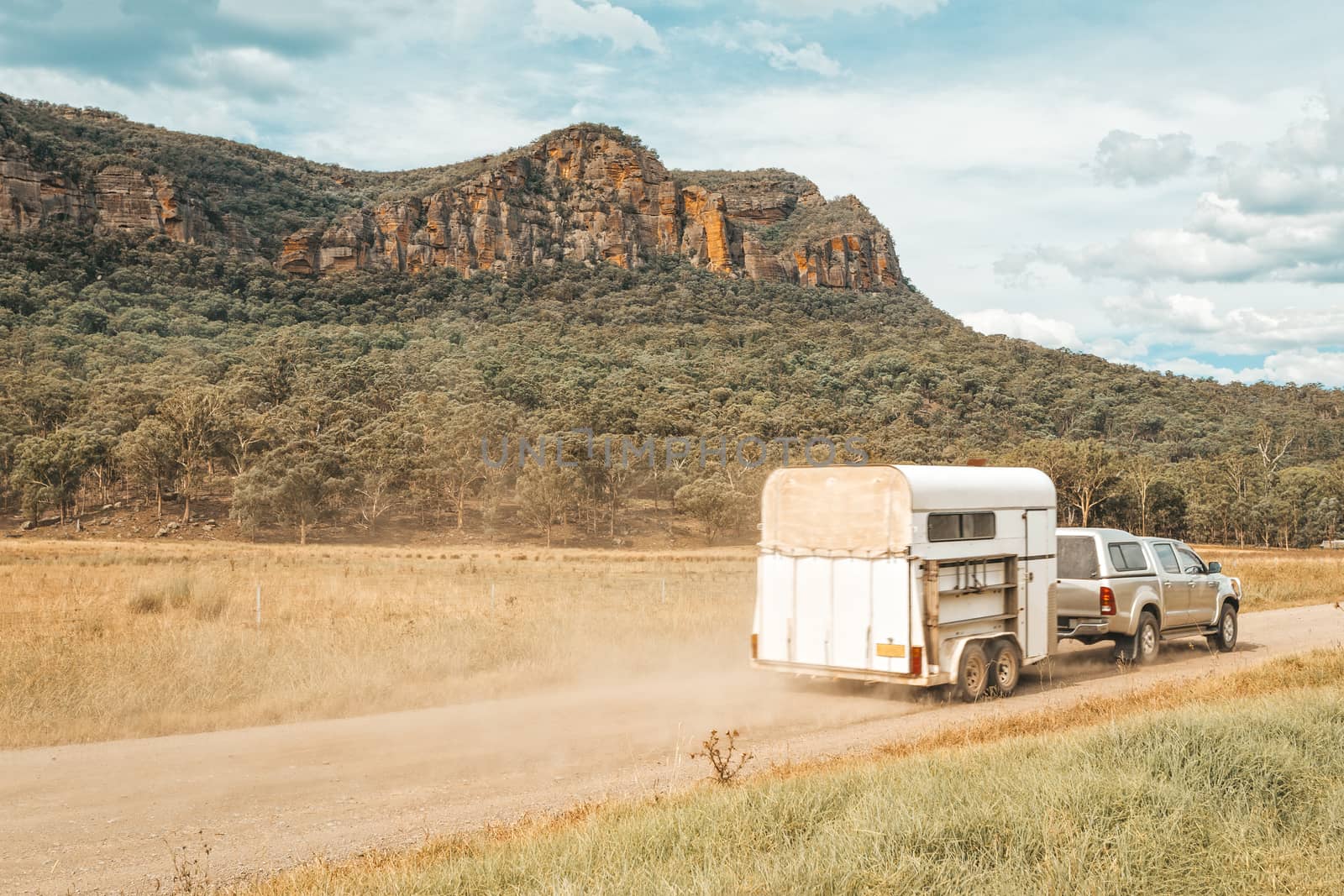 Horse float pulled by four wheel drive along a dirt road in rural Australia by lovleah