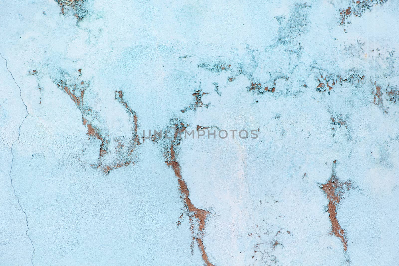 Old pastel blue wall with abrasions. Background with marble effect, copy space, minimal style backdrop.