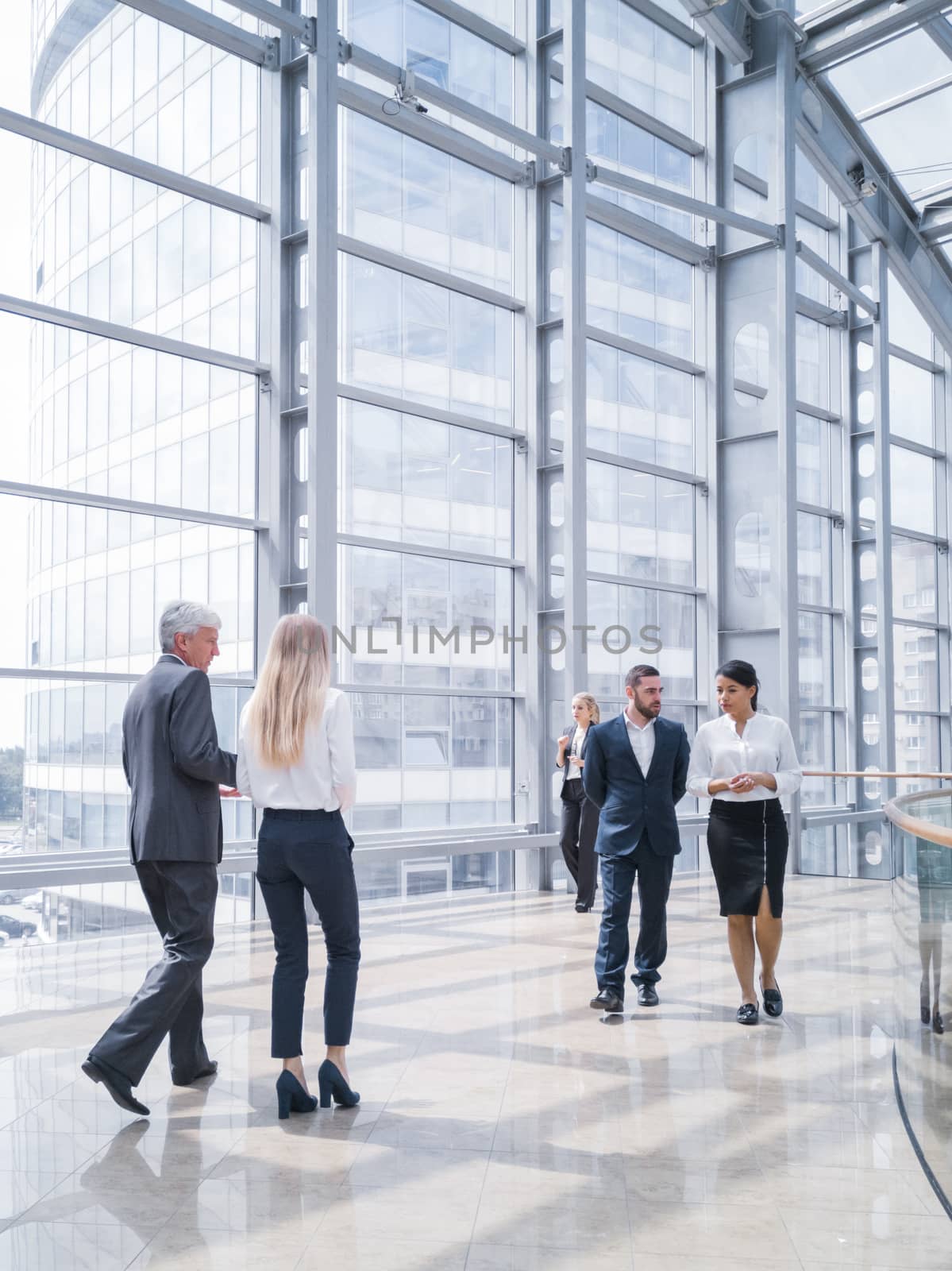 Business people walking in a modern hall of office building