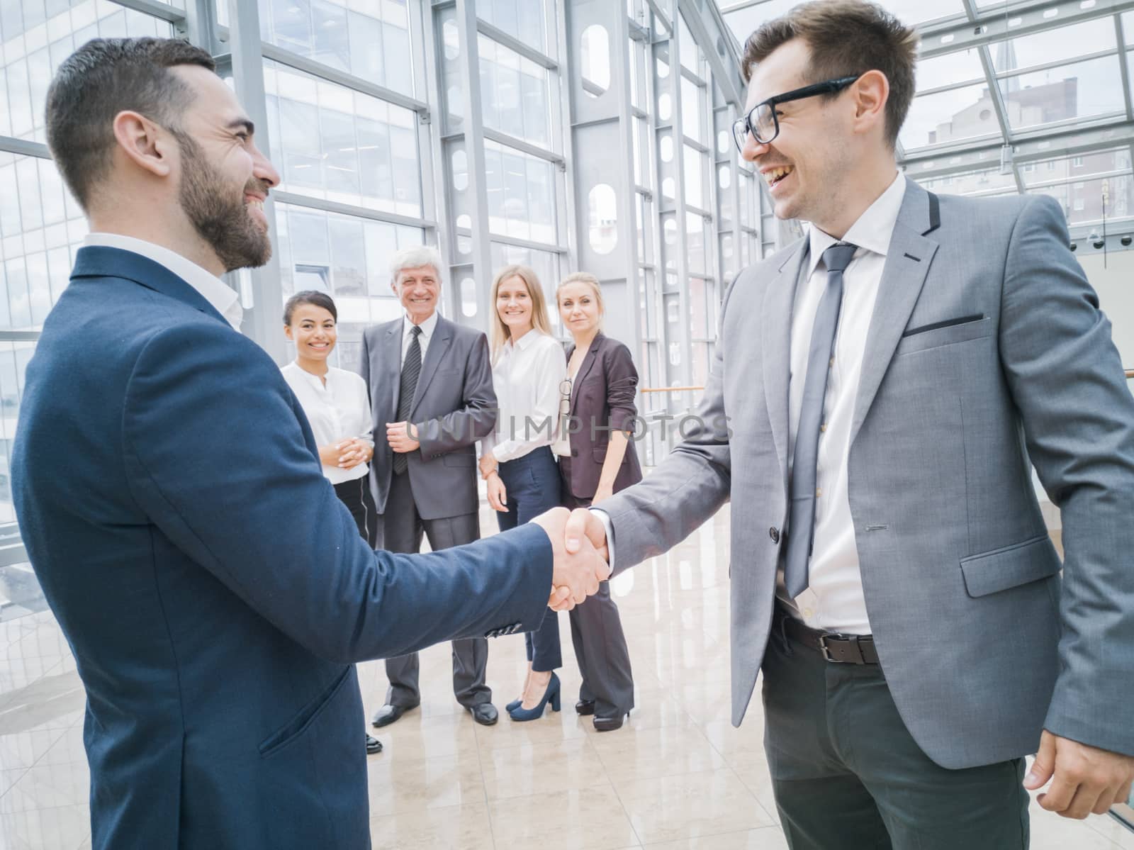 Handshake of business people in the lobby of an office building