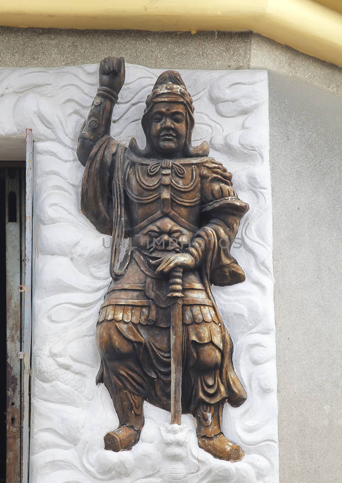 Warrior relief at the entrance of a Buddhist temple, Vietnam